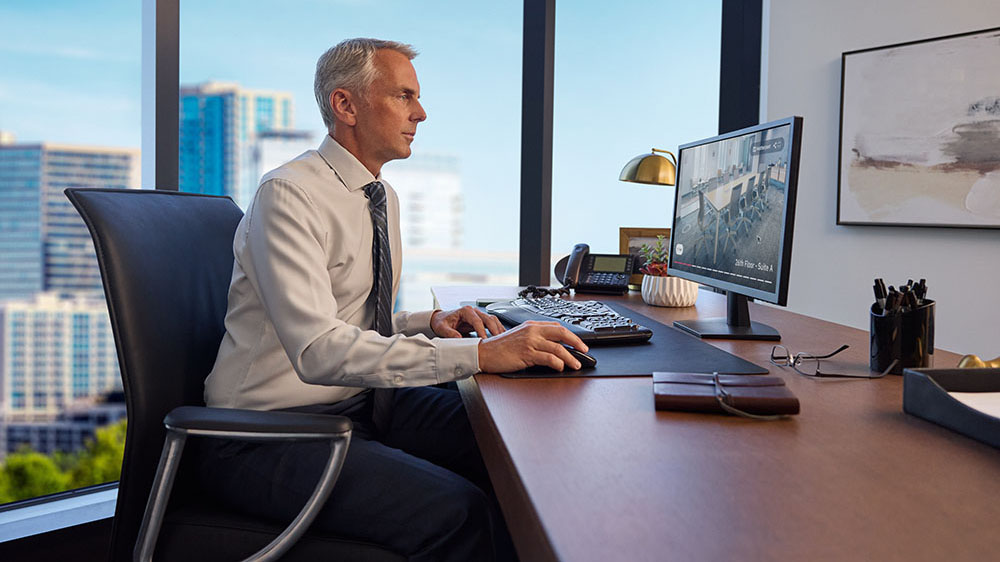Matterport example of a person reviewing an office-space tour on a desktop computer